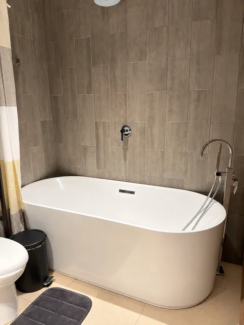 Bathroom with bathtub and rain shower