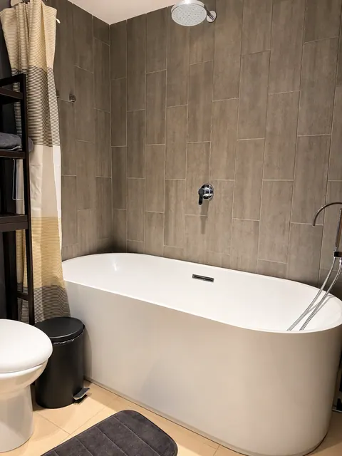 Bathroom with bathtub and rain shower