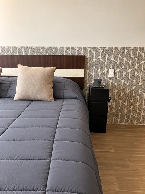 Bedroom with king-size bed and wooden headboard