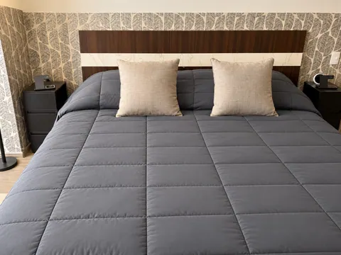 Bedroom with king-size bed and wooden headboard